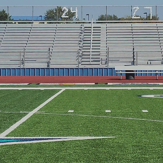 Video of an elementary school athlete during gait capture, side view of them running on the track.