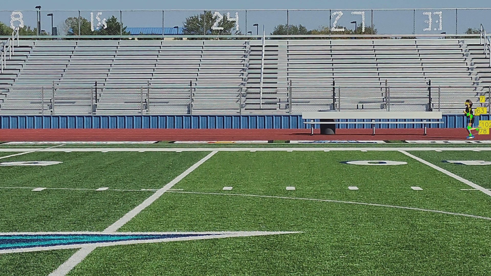 Video of an elementary school athlete during gait capture, side view of them running on the track.