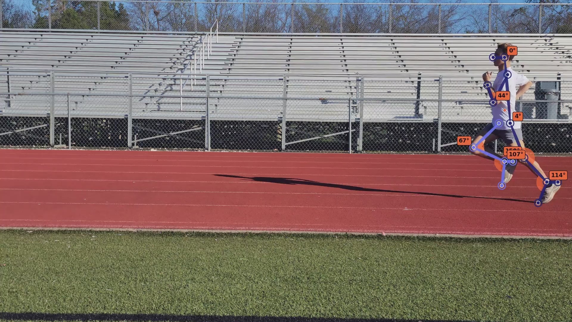 Video of a high school athlete during gait capture, side view of them running on the track.
